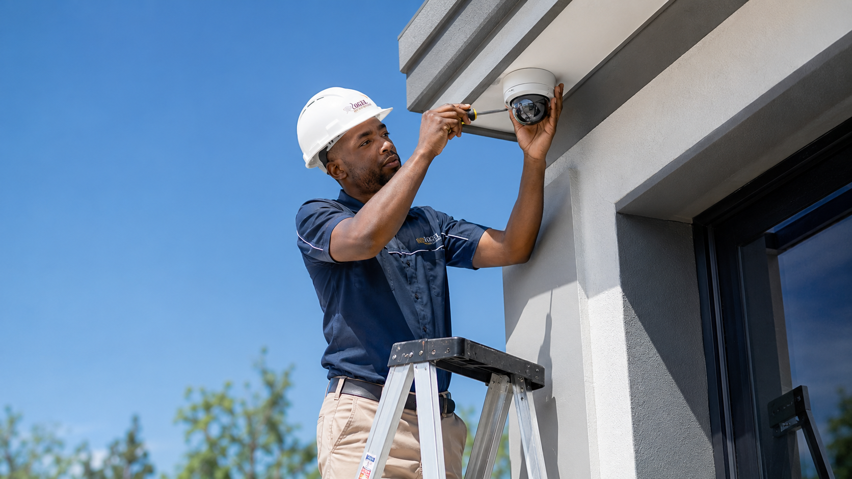 Rogel electronics technician installing a CCTV camera