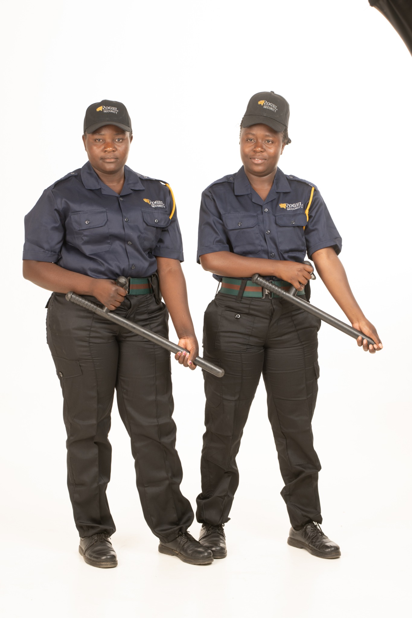 Two Rogel Security female officers holding batons in studio